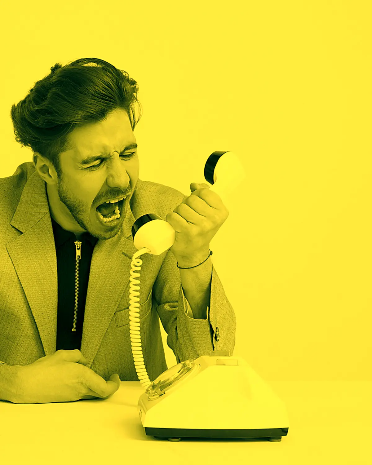 Man shouting into a rotary phone handset, in Keller's yellow duotone